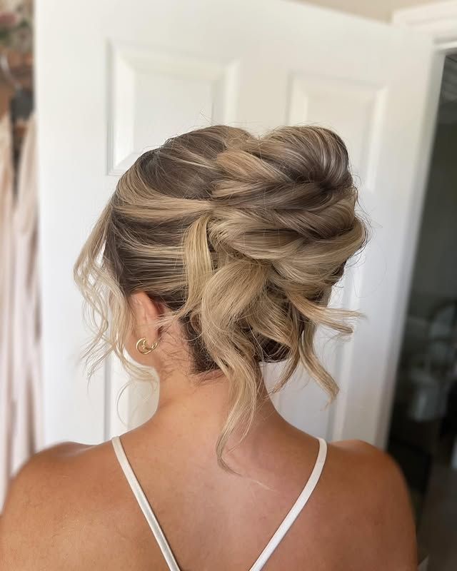Textured twisted updo with loose face-framing pieces